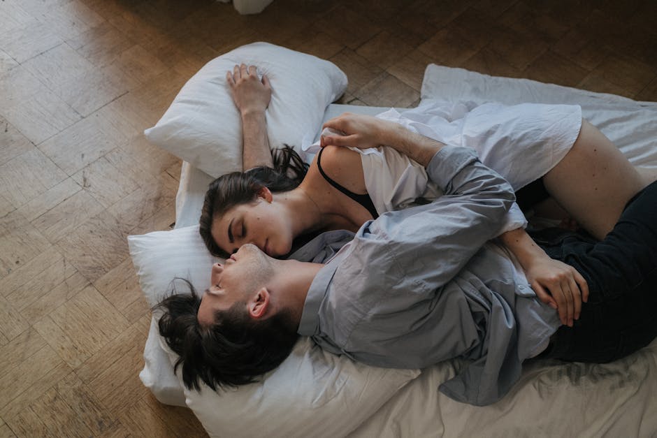 A couple embraces on a cozy floor setting, radiating warmth and intimacy.