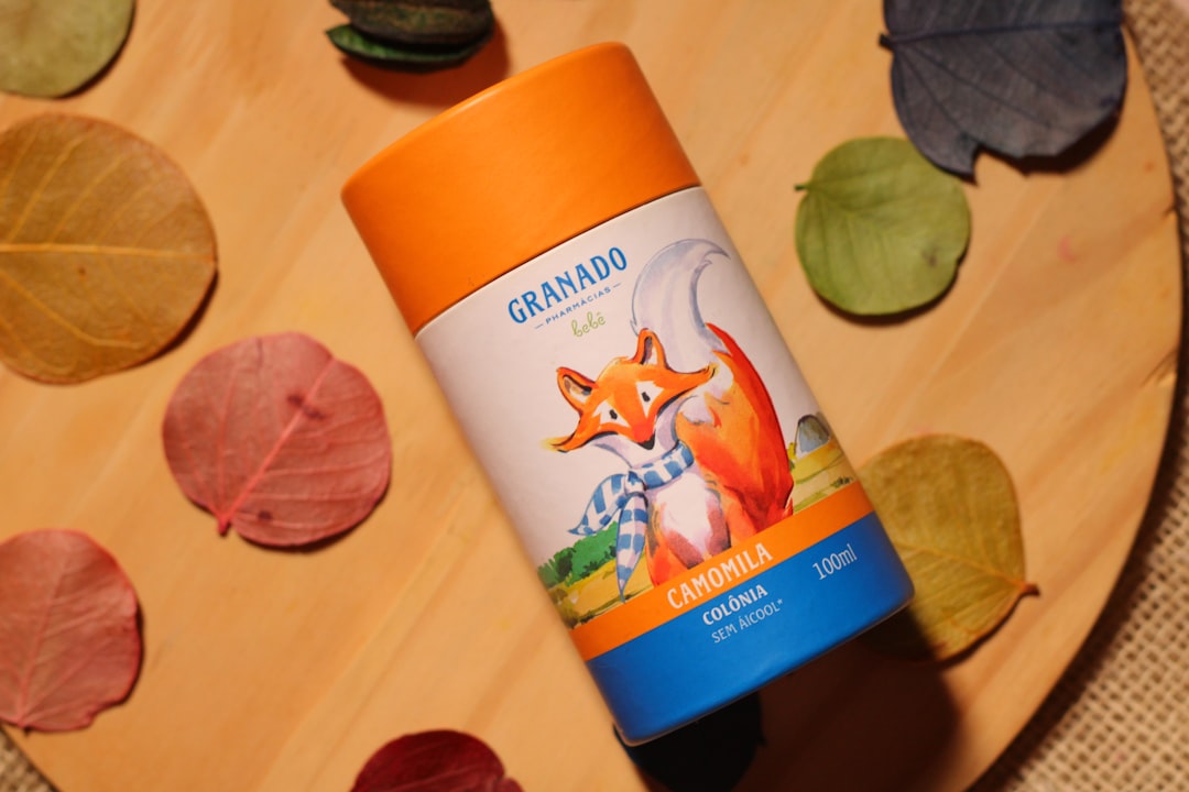 A bottle of sunscreen sitting on top of a wooden table