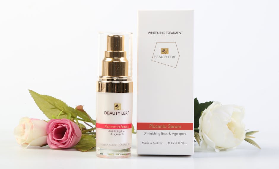 Elegantly arranged Beauty Leaf serum and box with roses on a crisp white backdrop.