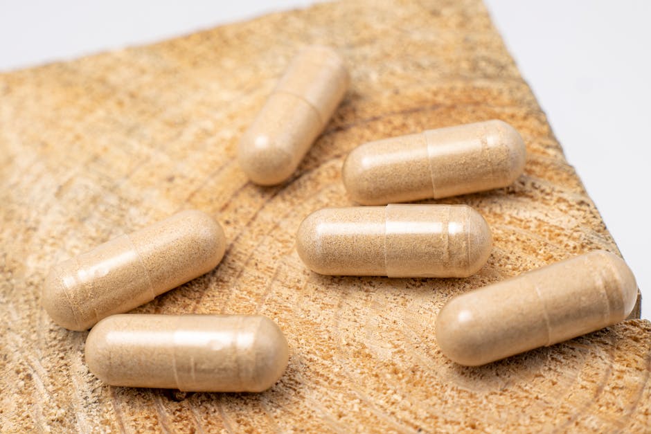 Close-up of beige supplements on a textured wooden surface, emphasizing natural health.